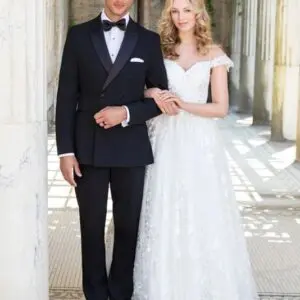 A man and woman in formal wear posing for the camera.