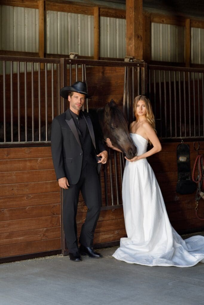 Couple in formal attire with horse in stable
