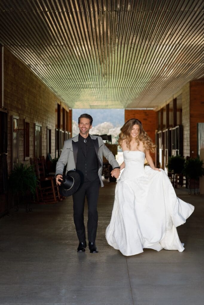 Bride and groom walking in rustic wedding venue