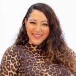 Smiling woman wearing leopard-print top