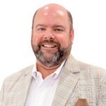 Smiling bearded man in plaid blazer