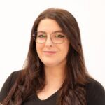 Smiling woman wearing glasses and black top