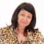 Portrait of smiling woman in leopard-print jacket